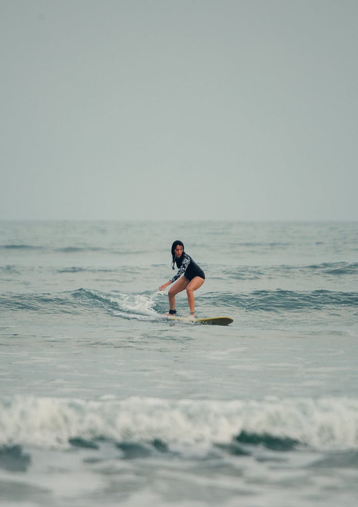 Woman Surfing on Waves